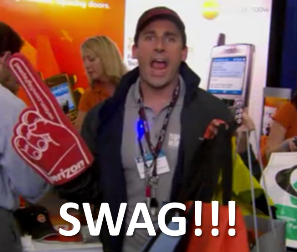 Michael Scott in the office showing branded swag items 