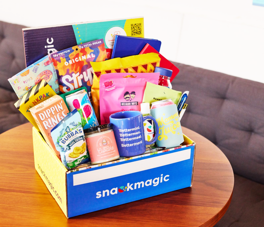 A box of snacks and swag on a table -  Best Retirement Gifts for Coworkers
