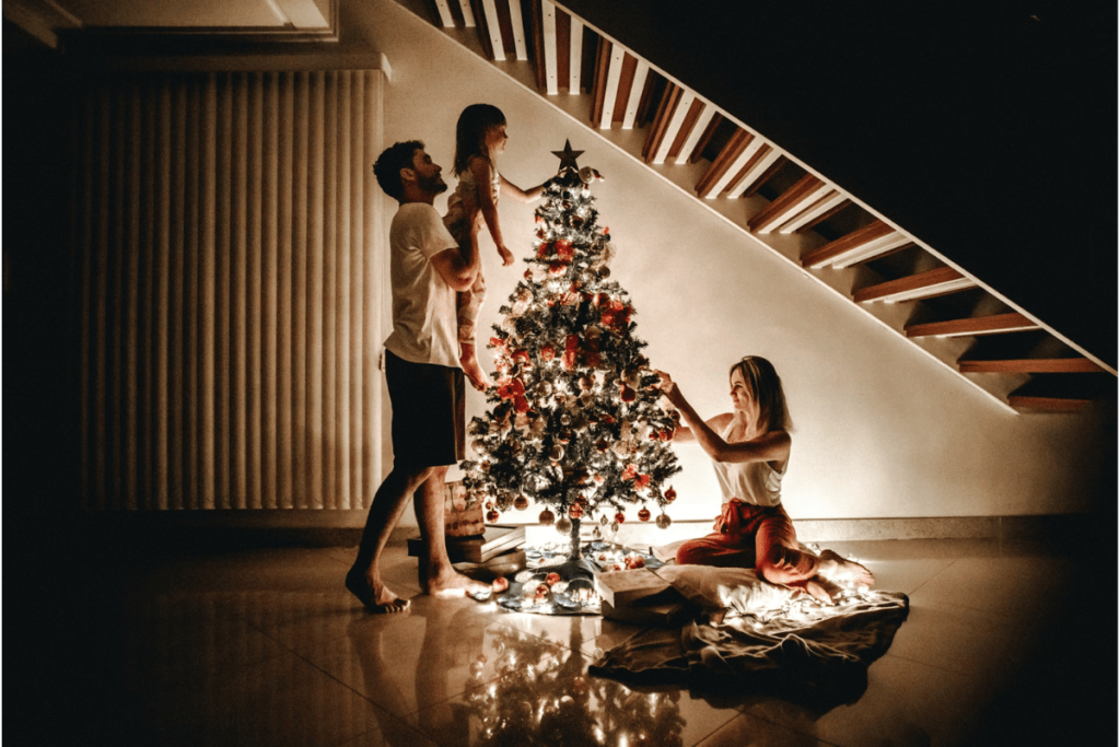 family decorating a xmas tree