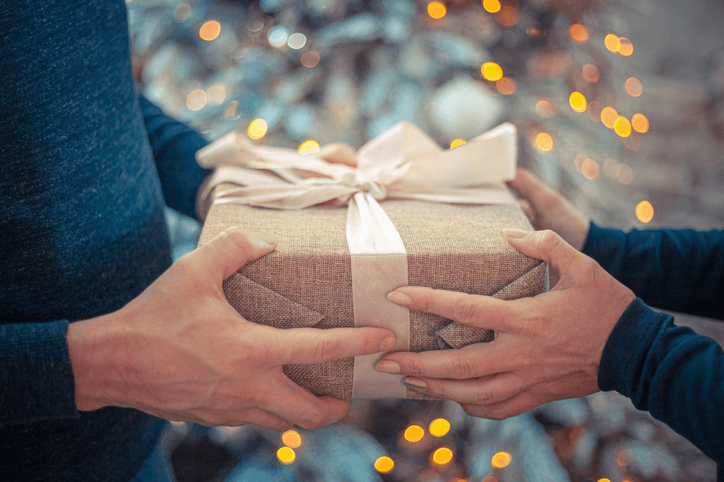 Two people exchange a gift of Hispanic Heritage Month.