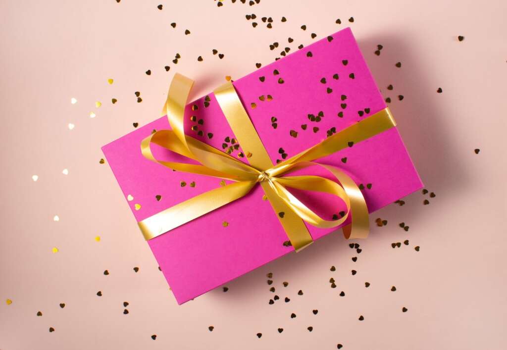 Picture of pink wrapped present with heart glitter.