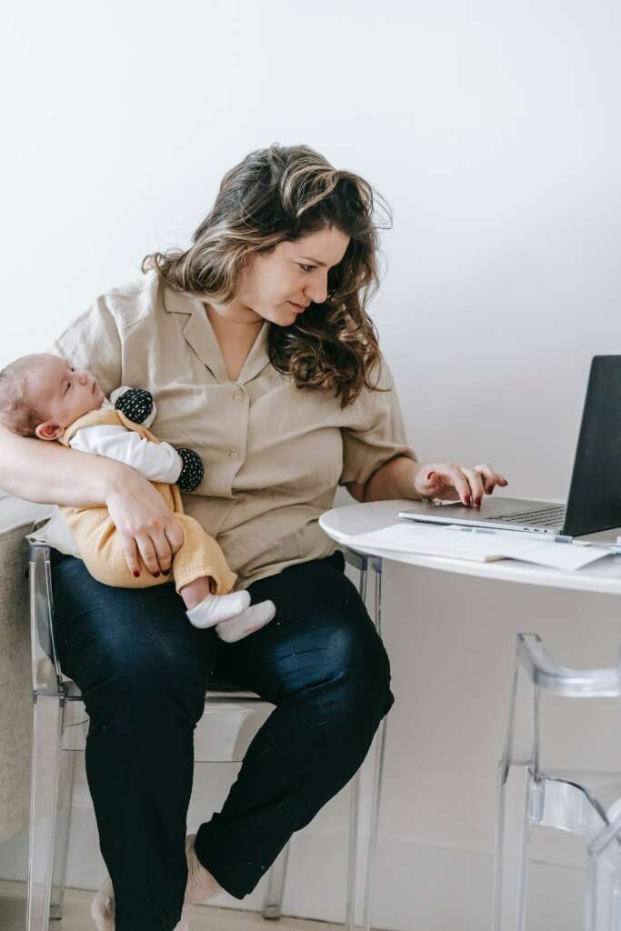 mom at laptop with her baby
