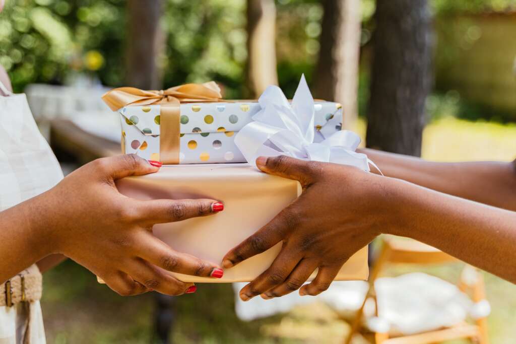 two people exchange a present 