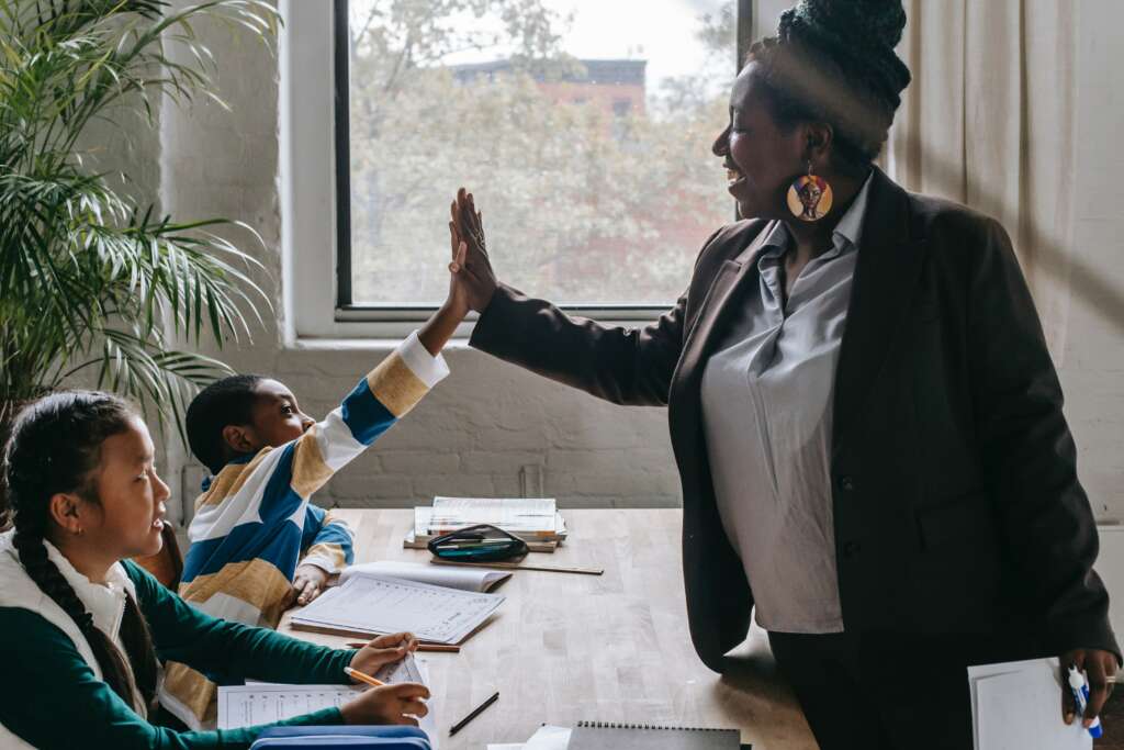 teacher high fiving student