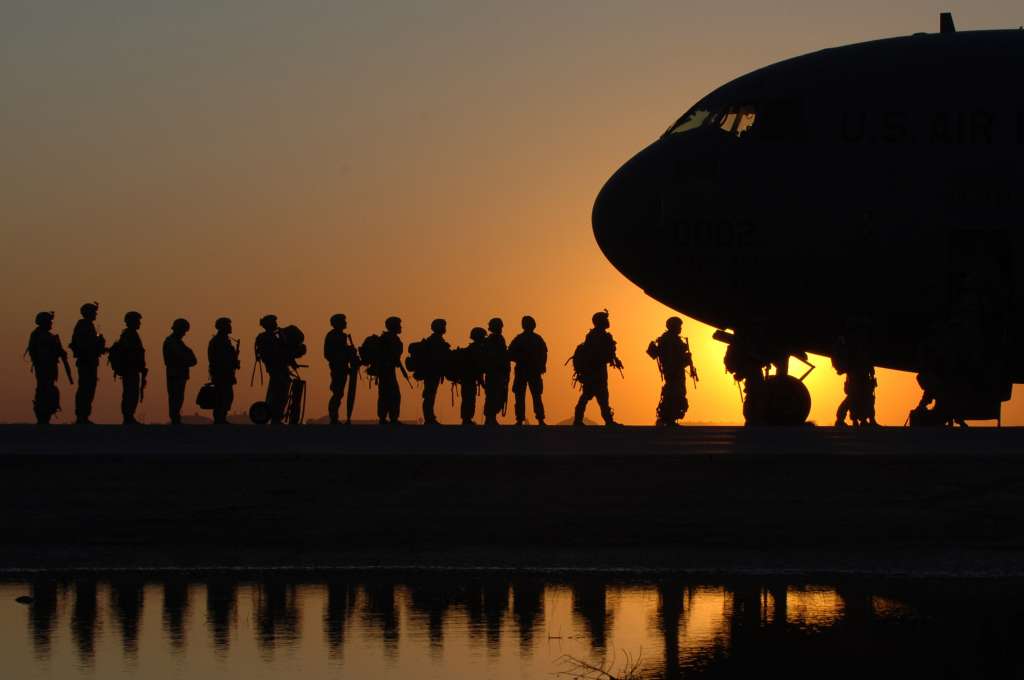 Soldiers getting on a plane 