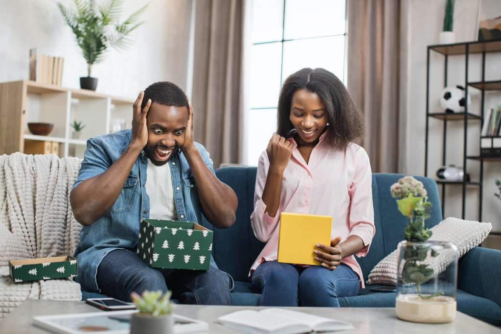 African american man and woman opening subscription gift boxes