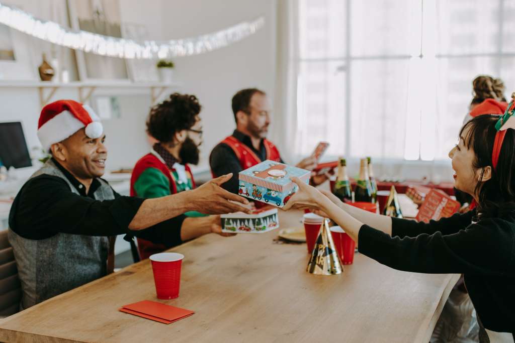 employees exchanging team gifts