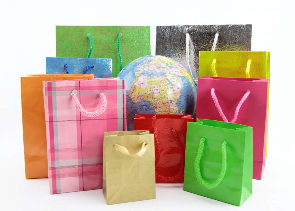 Shopping bags around of the world globe