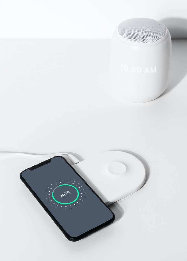 Smartphone on white wireless charger pad