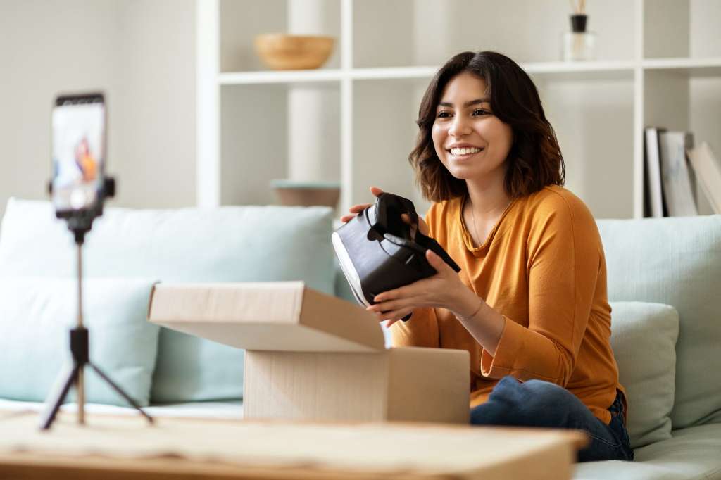 Tech Product Review. Arab Female Unboxing Parcel With VR Glasses At Camera