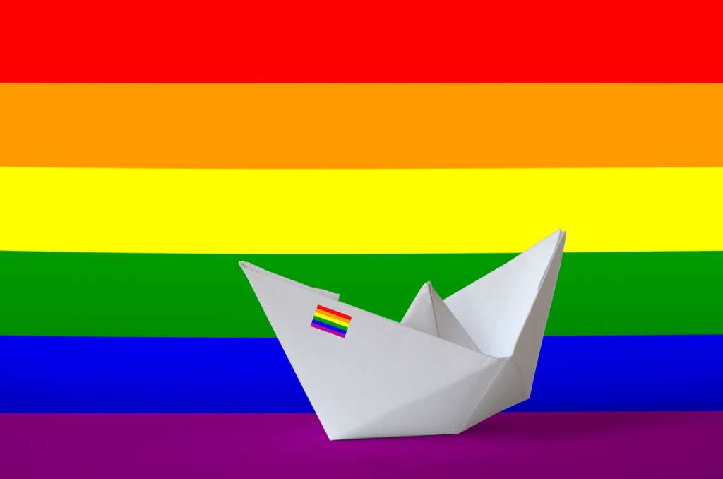 LGBT community flag depicted on paper origami ship 