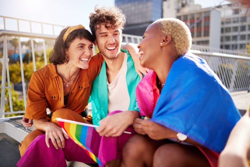LGBTQ, celebration and friends with flags in city for a pride parade or event for the community.