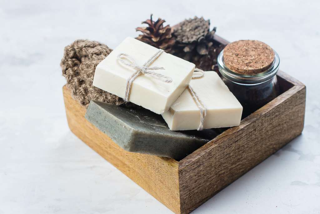 Spa, beauty skincare body concept. Handmade soap, coffee body scrub and body brush in wooden box