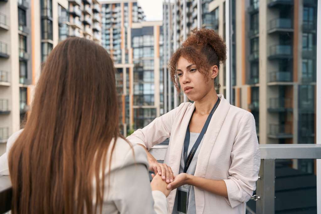 Caring company employee giving moral support to her coworker
