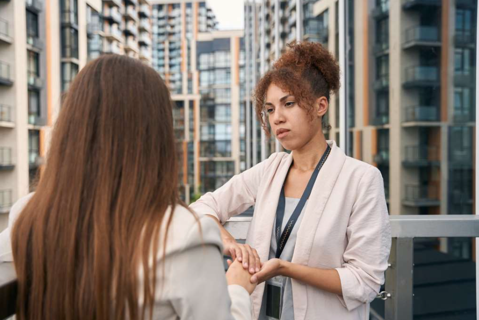 Caring company employee giving moral support to her coworker