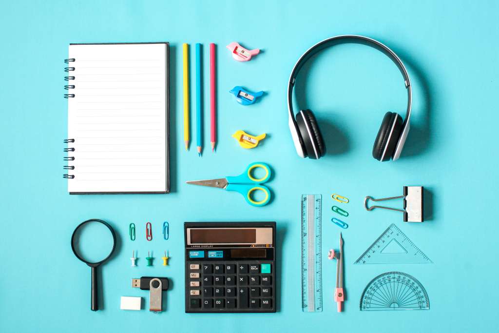 Flat lay of stationary on blue background