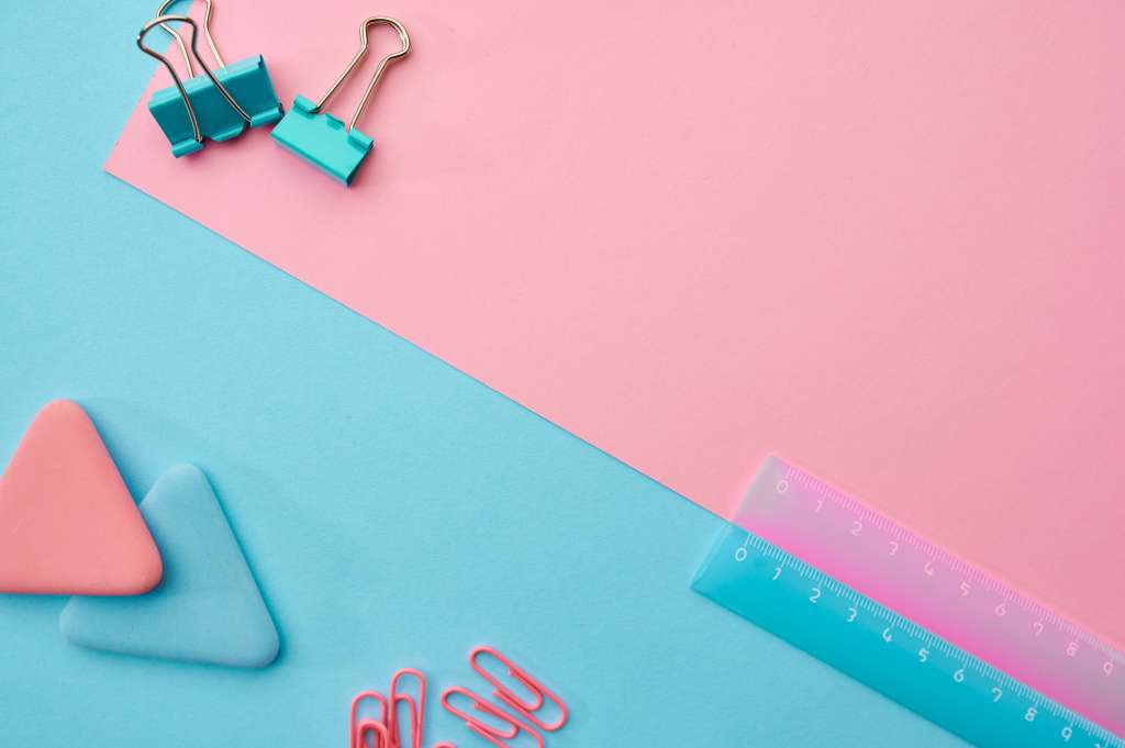 Paper clips, ruler, blue and pink background