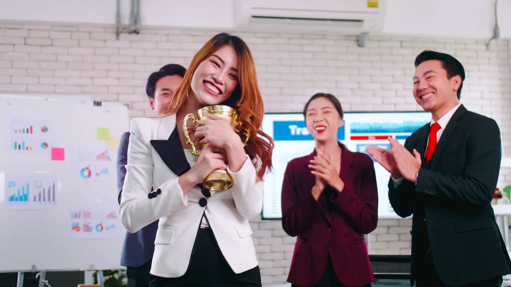 An employee of the company is proud to receive an award for a successful project.