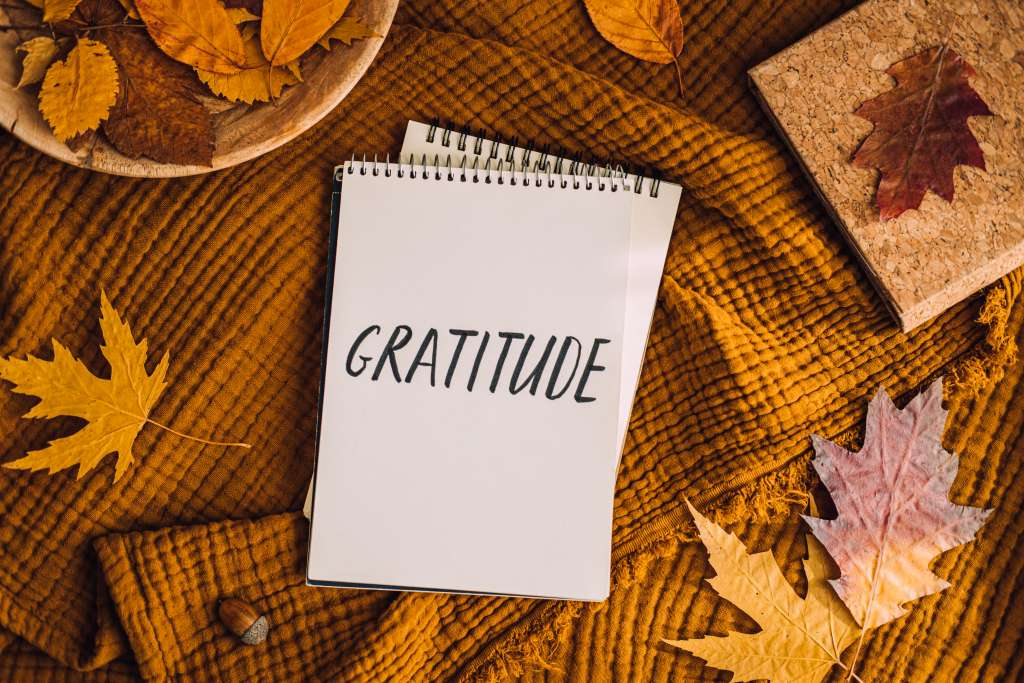 How to Practice Gratitude. Writing Autumn fall gratitude journal. Open paper notebook pages with