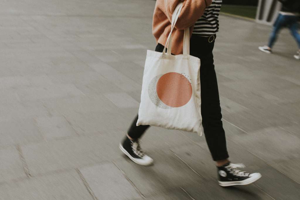 Woman carrying reusable canvas tote bag