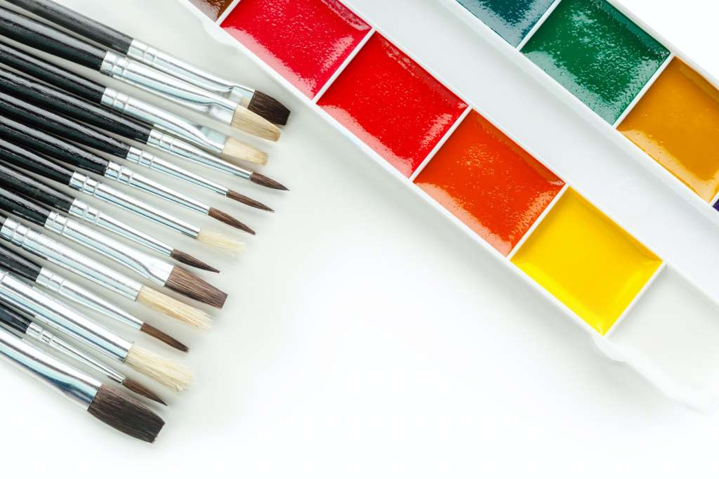 Set of watercolor paints and paintbrushes