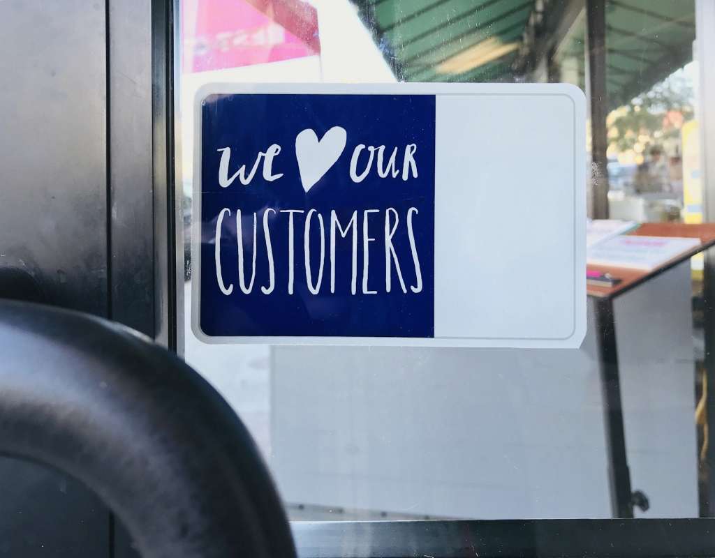 We love our customers sign on a door